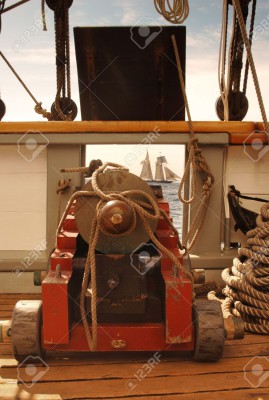 7060229-Looking-through-the-open-gun-port-on-a-vntage-sailing-ship-and-seeing-another-ship-in-the-opening-Stock-Photo.jpg